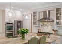 Well-lit kitchen featuring a granite countertop island and stainless steel appliances at 300 Livingstone Dr, Cary, NC 27513