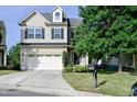 Attractive two-story home with a well-maintained lawn and a two-car attached garage at 306 Mainline Station Dr, Morrisville, NC 27560