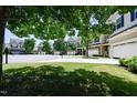 Street view of several similar two story homes with manicured lawns and lush green trees at 306 Mainline Station Dr, Morrisville, NC 27560