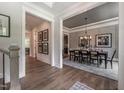 Dining room with elegant decor, modern light fixture, and grey paneled walls at 318 Ivy Ridge Rd, Chapel Hill, NC 27516