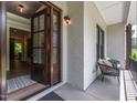 Inviting front porch with painted brick, chair, and striking wood and glass front doors at 318 Ivy Ridge Rd, Chapel Hill, NC 27516