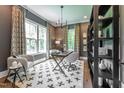Stylish home office with natural light, custom shelves and views of mature trees at 318 Ivy Ridge Rd, Chapel Hill, NC 27516