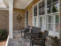 Cozy front porch featuring stone accents, comfortable seating, and a welcoming atmosphere at 3403 Raccoon Run Dr, Burlington, NC 27215