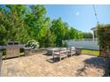 Inviting backyard patio area with outdoor seating, perfect for entertaining with outdoor kitchen, fire pit and lush garden at 3678 Horton Hill Dr, New Hill, NC 27562