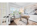 Bright home office with hardwood floors, large window, desk, chair, and modern decor at 3678 Horton Hill Dr, New Hill, NC 27562