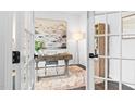 Bright home office with french doors, a stylish desk, neutral rug, and modern decor for a productive workspace at 3678 Horton Hill Dr, New Hill, NC 27562