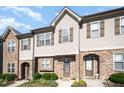 Attractive townhome showcasing a blend of stone and siding, accented by well-maintained front yard landscaping at 3945 Amelia Park Dr, Raleigh, NC 27606
