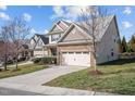 Charming homes featuring stone accents, two-car garages, and well-maintained front yards along a quiet street at 4 Seawell Ct, Durham, NC 27703