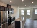 Modern kitchen features stainless appliances, granite countertops, and ample cabinet space at 4002 Silver Oak Ln, Durham, NC 27703