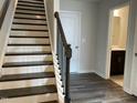 View of the entry stairs with hardwood flooring leading to upper level at 4002 Silver Oak Ln, Durham, NC 27703
