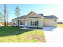 Inviting one-story home featuring a side entry garage and manicured lawn at 404 S Eastwood Dr, Benson, NC 27504