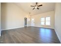 Open living room with wood flooring, high ceilings, and ample natural light at 404 S Eastwood Dr, Benson, NC 27504
