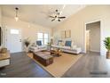 Bright living room featuring a ceiling fan, gray flooring, and neutral walls at 404 S Eastwood Dr, Benson, NC 27504