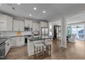 Spacious kitchen with white cabinets, stainless steel appliances, island with seating, and an open floor plan at 43 Quarter Gate Trce, Chapel Hill, NC 27516