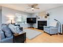 Cozy living room features a fireplace, ceiling fan, comfortable seating, and plenty of natural light at 504 High Ridge Dr, Durham, NC 27707
