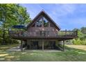 Back elevation of the house with a wrap around deck and stone facade at 506 Burgess Rd, Apex, NC 27523