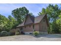 The side of the house features a large deck, yard and gravel driveway at 506 Burgess Rd, Apex, NC 27523