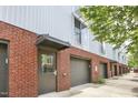 Street-level exterior featuring brick accents, private garage, and modern architectural details at 506 N Mangum St # 402, Durham, NC 27701