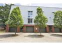 Contemporary building featuring a metal facade, brick accents, and private garage spaces at 506 N Mangum St # 402, Durham, NC 27701