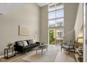 Bright living room featuring soaring ceilings and a wall of windows for natural light and views at 506 N Mangum St # 402, Durham, NC 27701