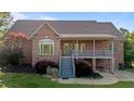 Brick home with an open deck and outdoor living space for relaxing and entertaining guests at 5250 Sartin Rd, Burlington, NC 27217