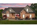 Stunning brick home featuring well-maintained landscaping and a charming covered entrance at 5250 Sartin Rd, Burlington, NC 27217