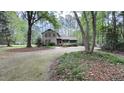 A charming two-story home with mature trees, lush landscaping and a long, inviting driveway at 5728 Carriagehouse Ct, Apex, NC 27539