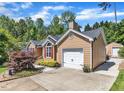 Side view of a cozy single-Gathering home with an attached garage and a well-manicured lawn at 5909 Royal Coach Ct, Raleigh, NC 27612