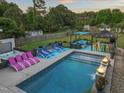 Backyard featuring a sparkling pool, an outdoor kitchen, and a lounge area for relaxation at 60 Consella Way, Franklinton, NC 27525