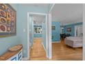 Bright foyer with hardwood floors and blue walls leading to the living spaces, creating a seamless flow at 600 Longleaf Dr, Chapel Hill, NC 27517