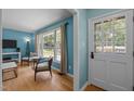 Inviting living room with hardwood floors, large windows, and comfortable seating, creating a cozy atmosphere at 600 Longleaf Dr, Chapel Hill, NC 27517