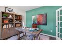 Stylish home office with a modern desk, shelves, artwork, and a comfortable chair on a rug at 701 Holstein Dairy Way, Wake Forest, NC 27587