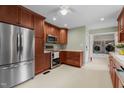 Modern kitchen with stainless steel appliances and rich wood cabinets with access to the laundry room at 702 Wedgewood Ave, Zebulon, NC 27597