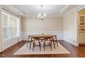 Bright dining room with large window, hardwood floors, and modern chandelier at 704 Long Lake Dr, Fuquay Varina, NC 27526