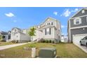 Well-maintained home with gray siding, a brick-lined staircase, green lawn, and manicured landscaping at 712 Emmer St, Rolesville, NC 27571