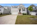 Two-story home with a gray exterior, a brick-lined staircase, and an attached two-car garage at 712 Emmer St, Rolesville, NC 27571