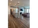 Open-concept kitchen with stainless steel appliances, a large island, and hardwood floors at 712 Emmer St, Rolesville, NC 27571