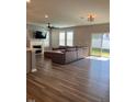 Spacious living room featuring hardwood floors, fireplace, and large windows for natural light at 712 Emmer St, Rolesville, NC 27571