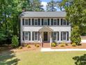 Classic two-story home showcasing well-placed landscaping, and traditional curb appeal at 7204 Laketree Dr, Raleigh, NC 27615