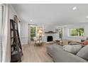 Bright living room features a fireplace, neutral decor and wood floors at 7204 Laketree Dr, Raleigh, NC 27615