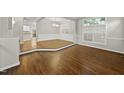 Open concept dining area with hardwood floors, white trim, and abundant natural light at 7340 Doverton Ct, Raleigh, NC 27615