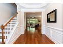 Open foyer with hardwood floors that leads to the spacious living room and staircase at 7660 Channery Way, Raleigh, NC 27616