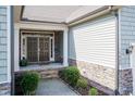 Inviting front entrance with double doors, stone accents, and well maintained landscaping at 7660 Channery Way, Raleigh, NC 27616