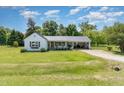 Inviting single-Gathering home featuring a well-manicured front yard and metal roof carport at 80 Lewis Moody Rd, Bear Creek, NC 27207