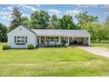 Charming single-Gathering home featuring a welcoming front porch and attached carport with a metal roof at 80 Lewis Moody Rd, Bear Creek, NC 27207