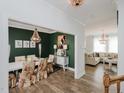 Elegant dining room featuring a chandelier, green accent wall, and a view of the living room at 808 Trinity Park Dr, Wake Forest, NC 27587