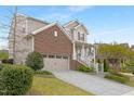 Beautiful two-story home with a two-car garage, brick accents, well-maintained lawn, and cozy porch at 844 Cozy Oak Ave, Cary, NC 27519