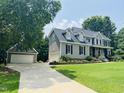 Traditional two-story home with a large lawn and a detached two-car garage at 8517 Falkirk Ridge Ct, Wake Forest, NC 27587