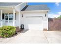 Attached two-car garage with a clean white door and concrete driveway at 901 N Taylor St, Wake Forest, NC 27587