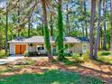 Inviting single-story home nestled among mature trees, featuring a quaint front porch at 9220 Old Cascade Dr, Garner, NC 27529